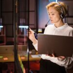 female-worker-wearing-headset-and-using-laptop